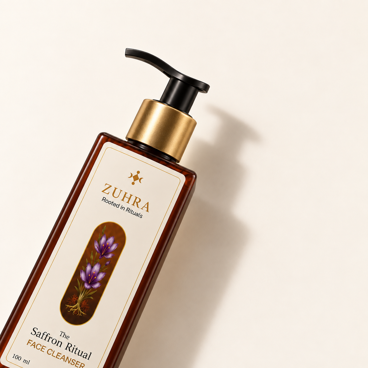 ZUHRA Saffron Face Cleanser bottle with gold pump, angled
