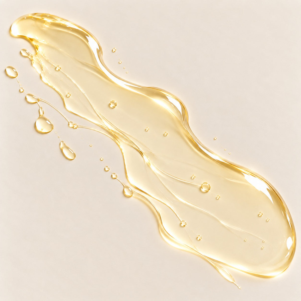 Texture of ZUHRA Saffron Shower Oil, a golden oil with water droplets